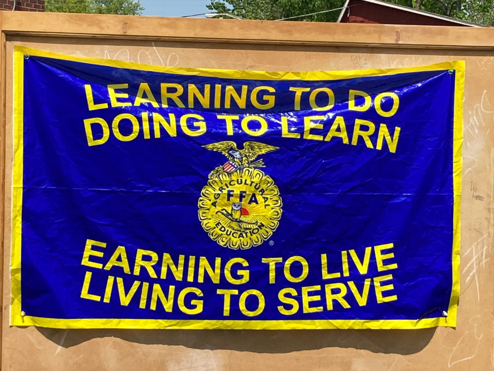 "Learning to do, doing to learn. Earning to live, living to serve." glag
